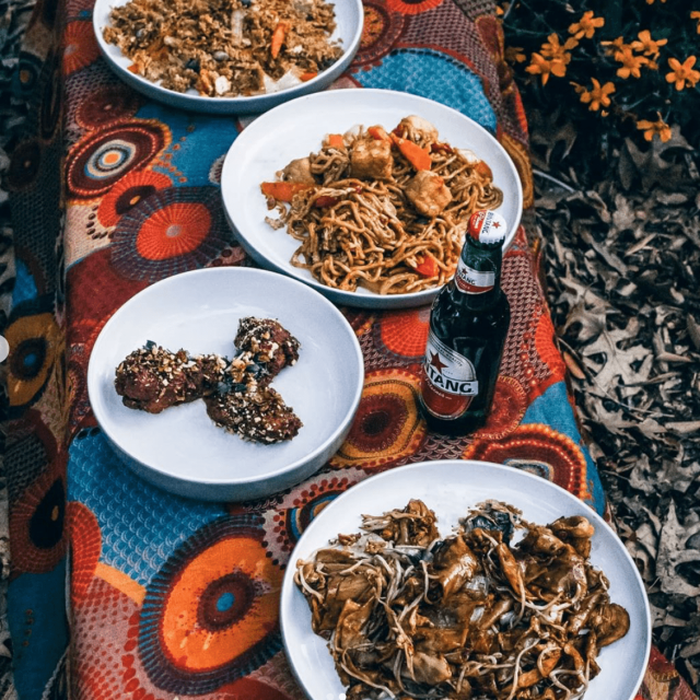 P'Nut's Indonesian dishes on a beautiful teal and orange table cloth featuring a traditional pattern.